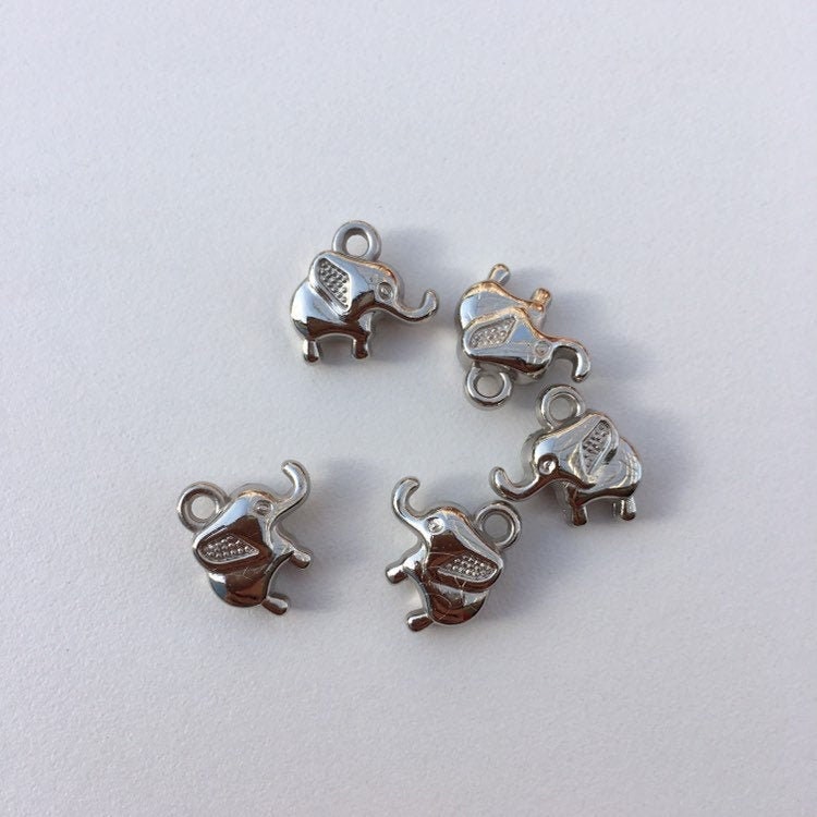 baby elephant charms on white background